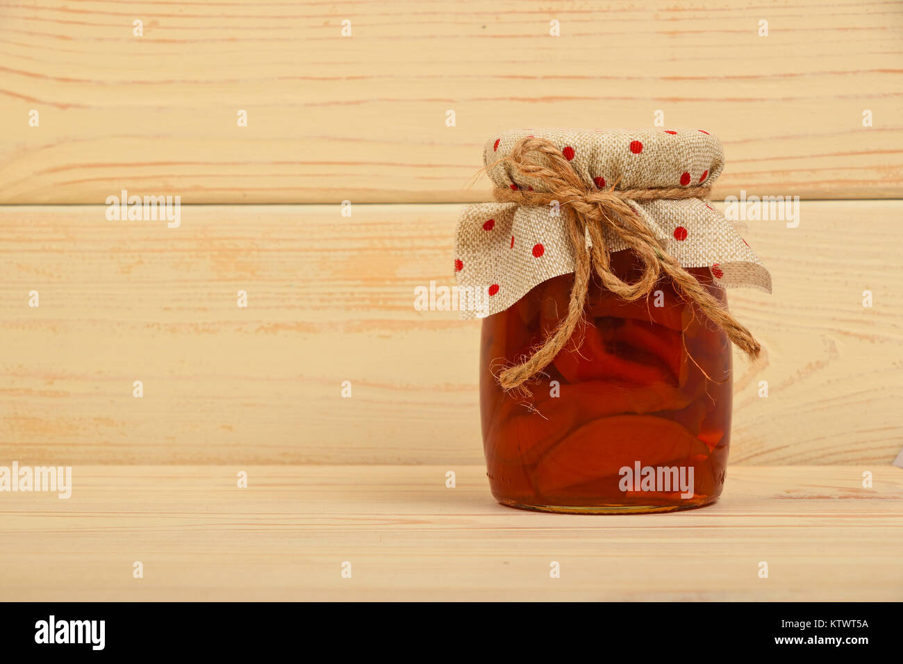 Close Up Of One Glass Jar Of Homemade Quince Jam With Textile Top