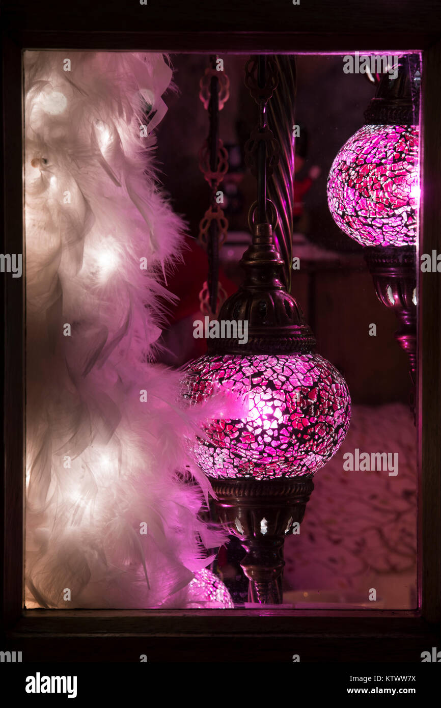 Decorative pink lamps in an antiques shop window at christmas. Stow on the Wold, Cotswolds, Gloucestershire, England Stock Photo