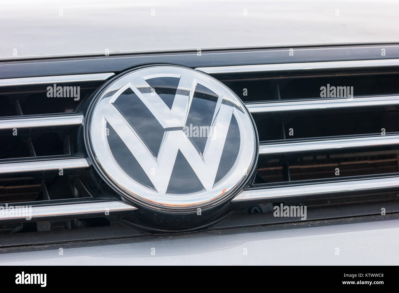Volkswagen VW logo on a silver car. Volkswagen is a famous European car manufacturer company based on Germany. Stock Photo