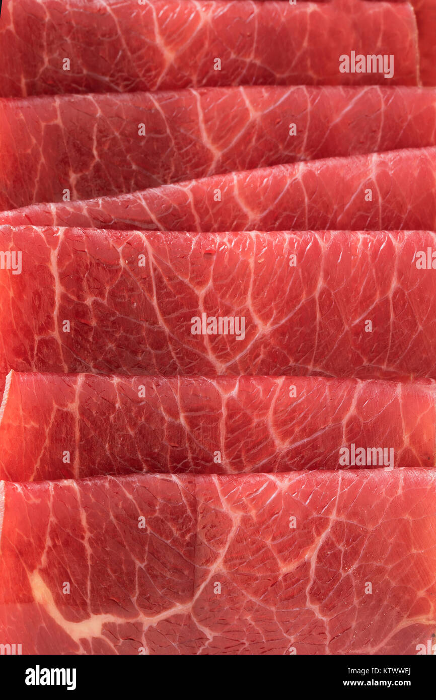 Close up of slices of bresaola, thin sliced cured beef. Stock Photo