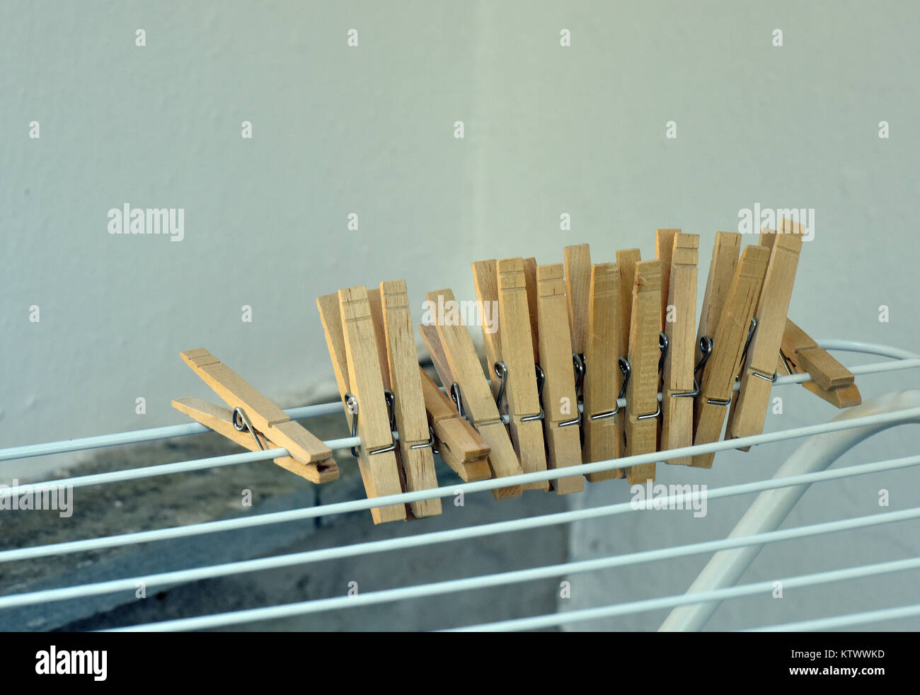 a number of wooden clothes pegs clipped or pegged to a washing line or