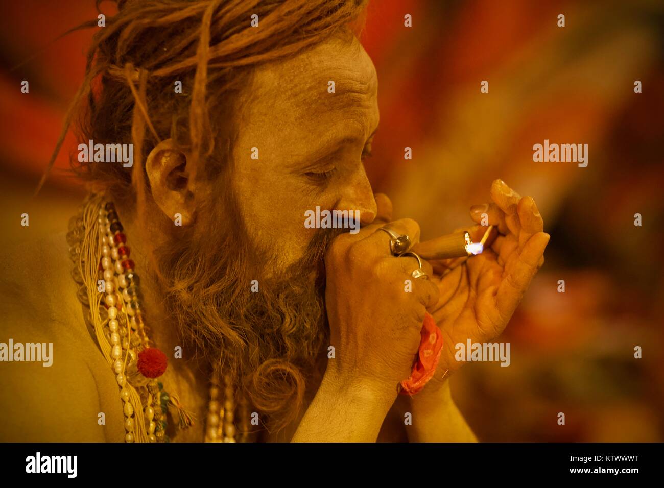 Indian naga baba sadhu lights chillum in 2013 Kumbh Mela in Allahabad (Prayaga) Stock Photo