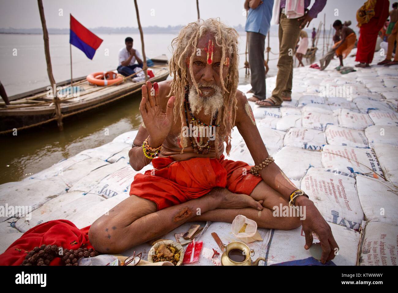 Kumbh Mela 2013 in Allahabad. Old Baba sitting at the shores of Sangham giving blessing and praying Stock Photo