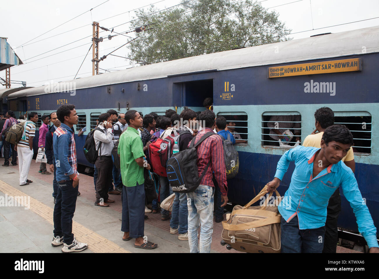 Passengers board a train at the railway station in Asansol, India Stock Photo