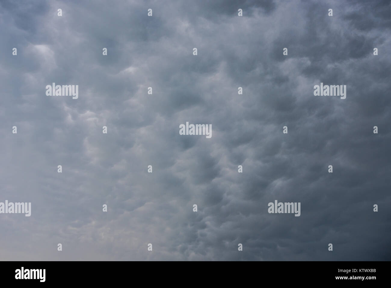 Bubbling Cloud Background with hint of dark storms Stock Photo