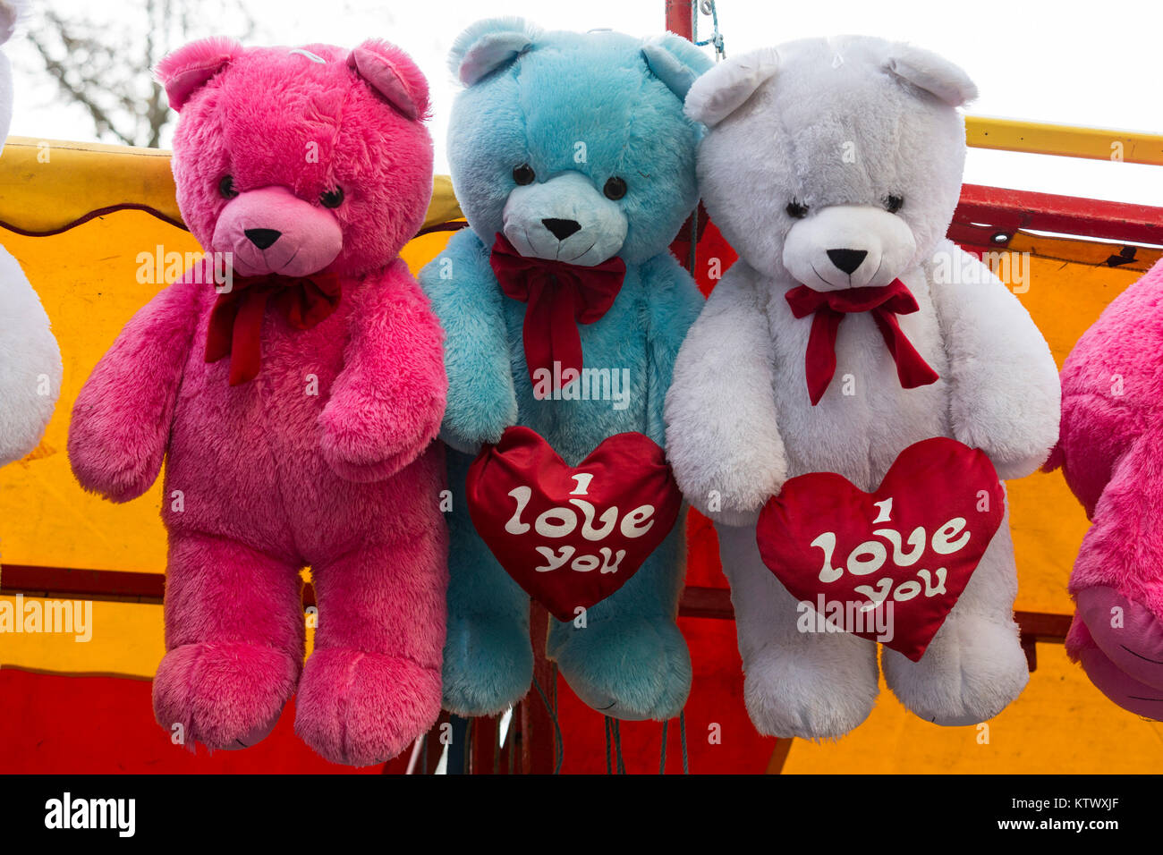 Three cuddly teddy bears, soft toys, holding an I love you heart ...