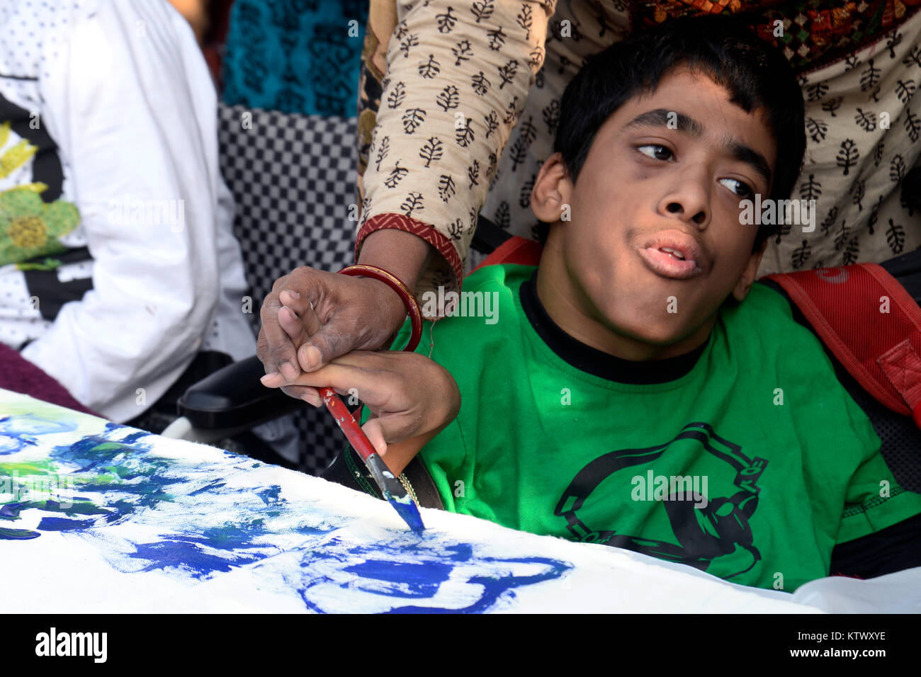 Kolkata, India. 27th Dec, 2017. Differently able children take part in a 50 ft greeting card painting themed Kanyashree on December 27, 2017 in Kolkata. Kanyashree Prakalpa is an initiative taken by the Government of West Bengal to improve life and the status of the girls by helping economically backward families with cash so that families do not arrange the marriage of their girl child before eighteen years because of economic problem. Credit: Saikat Paul/Pacific Press/Alamy Live News Stock Photo