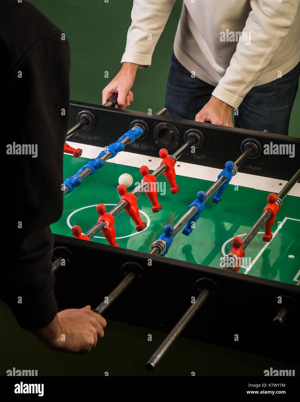 Two man playing foosball table game Stock Photo Alamy