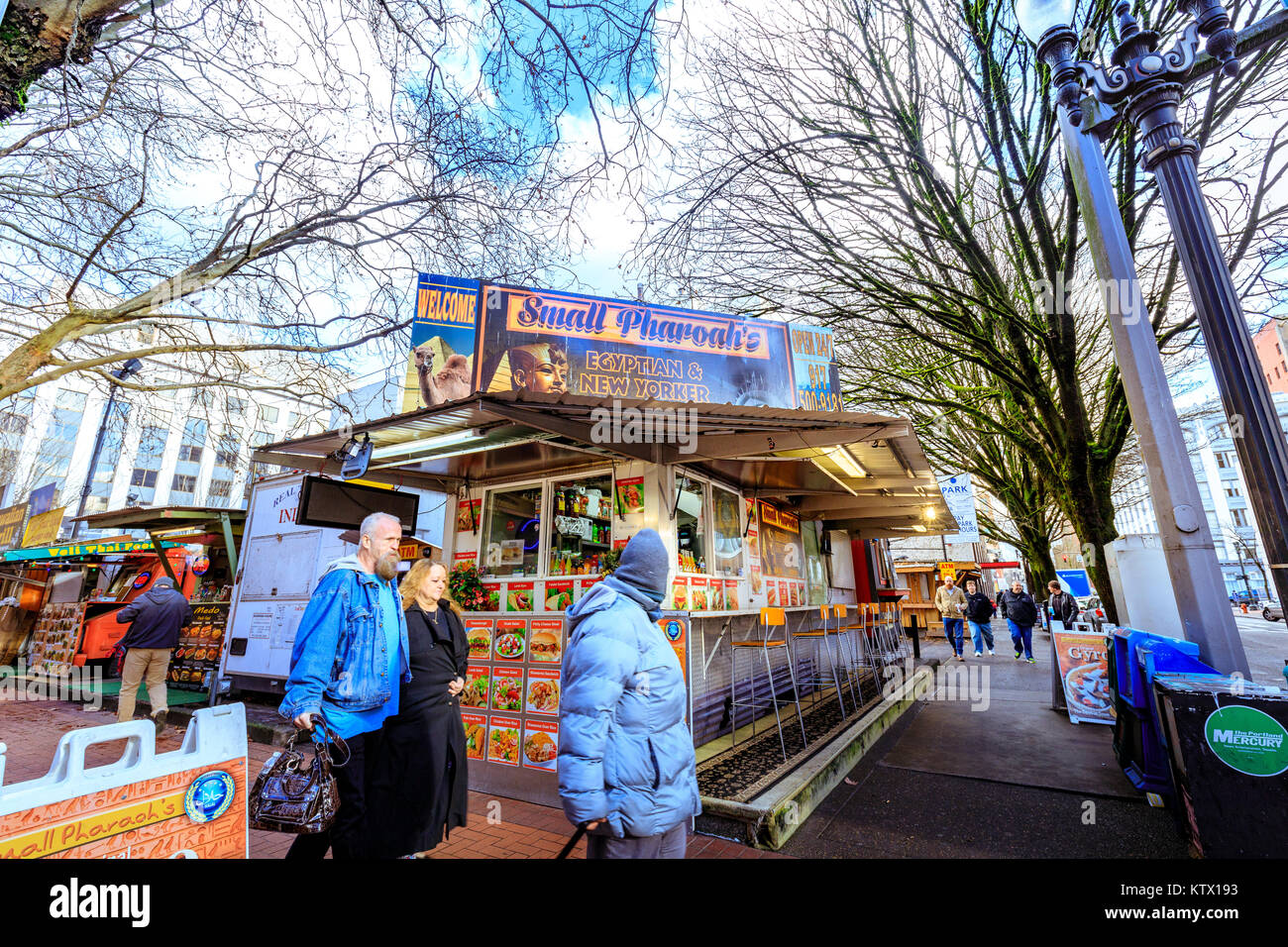 Portland, United States - Dec 21, 2017 : Food trucks and carts in downtown PDX offer lunch and other meails for inexpensive prices near major office b Stock Photo