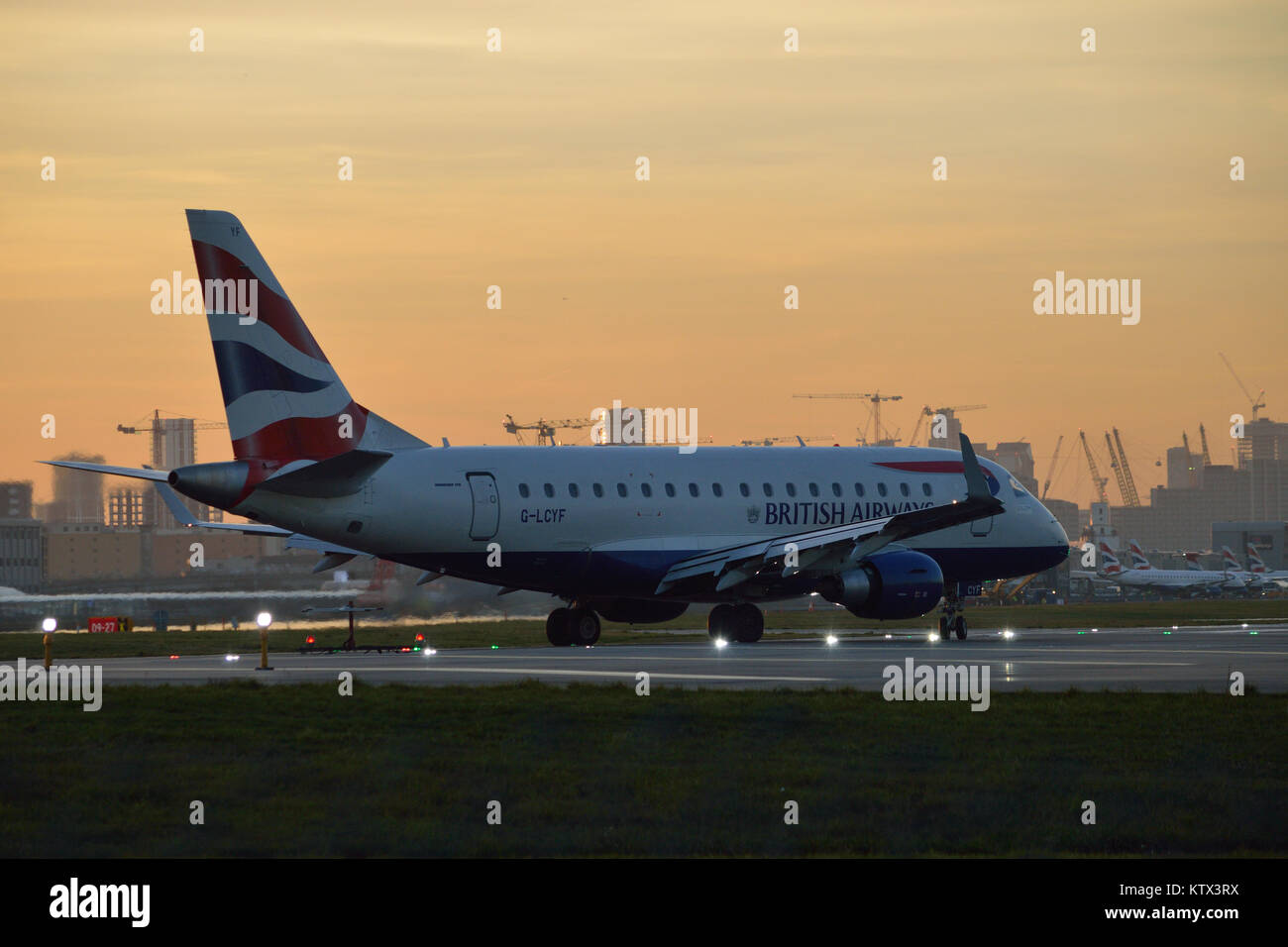 British Airways BA CityFlyer Embraer at London City Airport at dusk Stock Photo