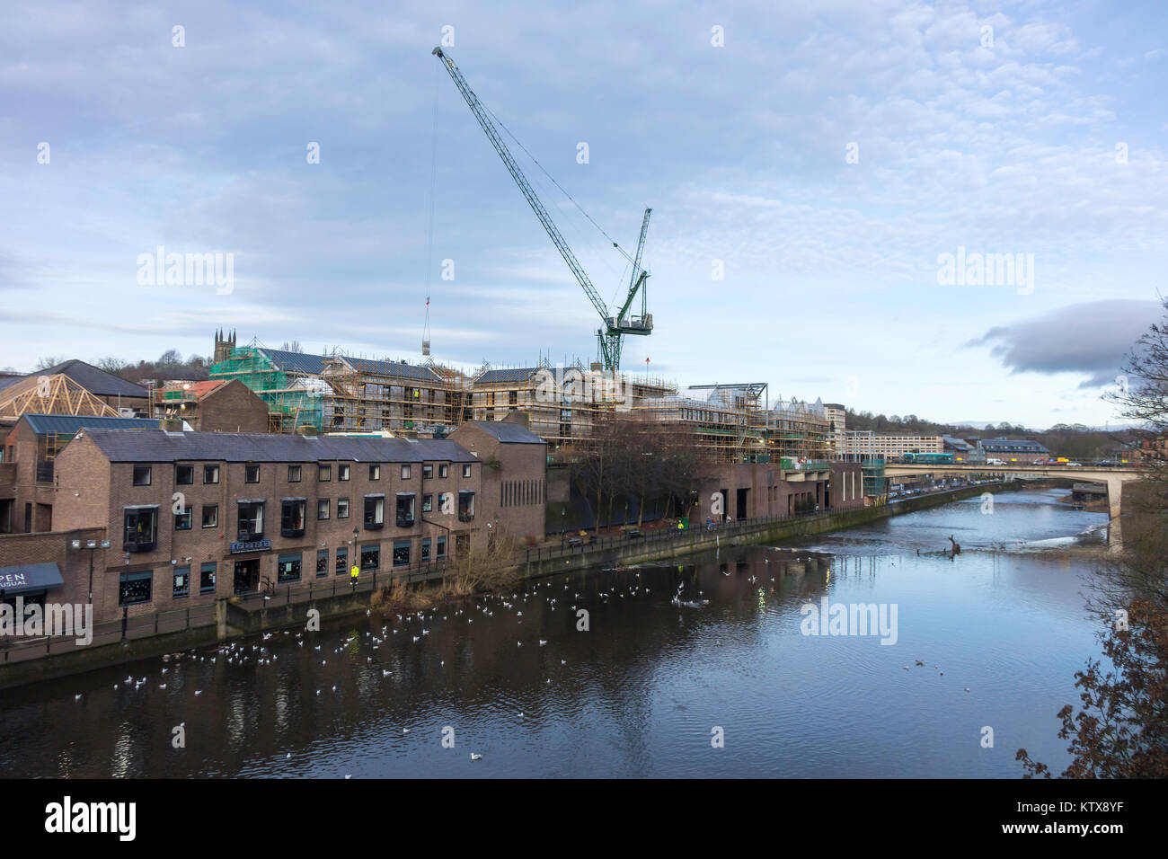 View from Framwellgate Bridge over the river Wear in Durham City Centre towards Milburngate redevelopment of the riverside with luxury accommodation Stock Photo