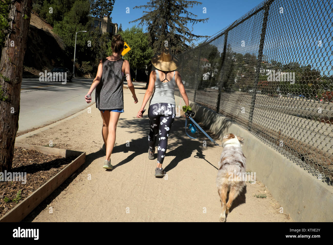 Women walking a dog around the Silverlake reservoir Silver Lake, neighbourhood neighborhood of Los Angeles, California USA    KATHY DEWITT Stock Photo