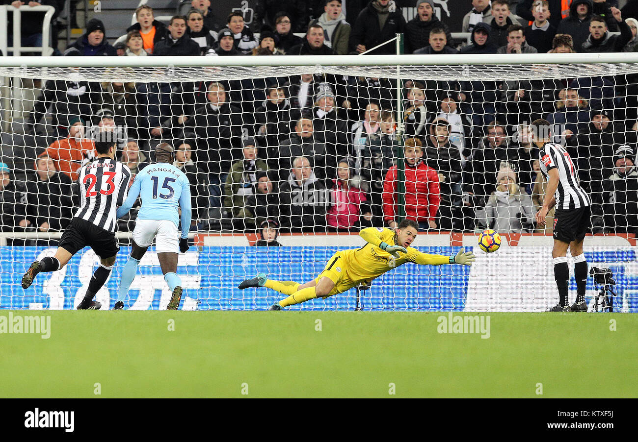 Manchester City goalkeeper Ederson (centre) dives as a header from ...