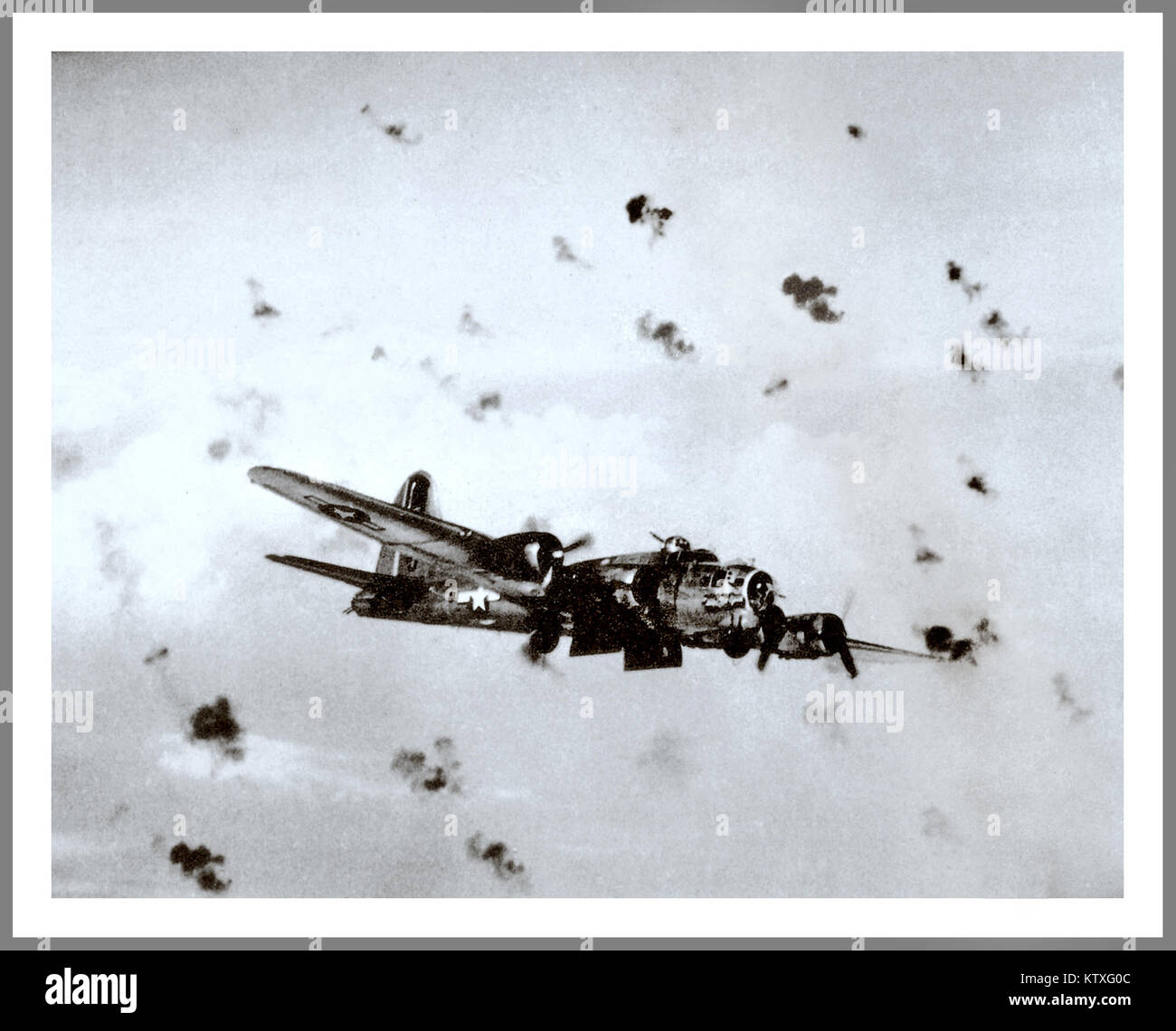 FLAK anti aircraft barrage USAAF World War 2 WW2 U.S. Army Air Force Boeing B-17G Flying Fortress flying through heavy flak with bomb doors open over a German target. 1944-1945 Stock Photo