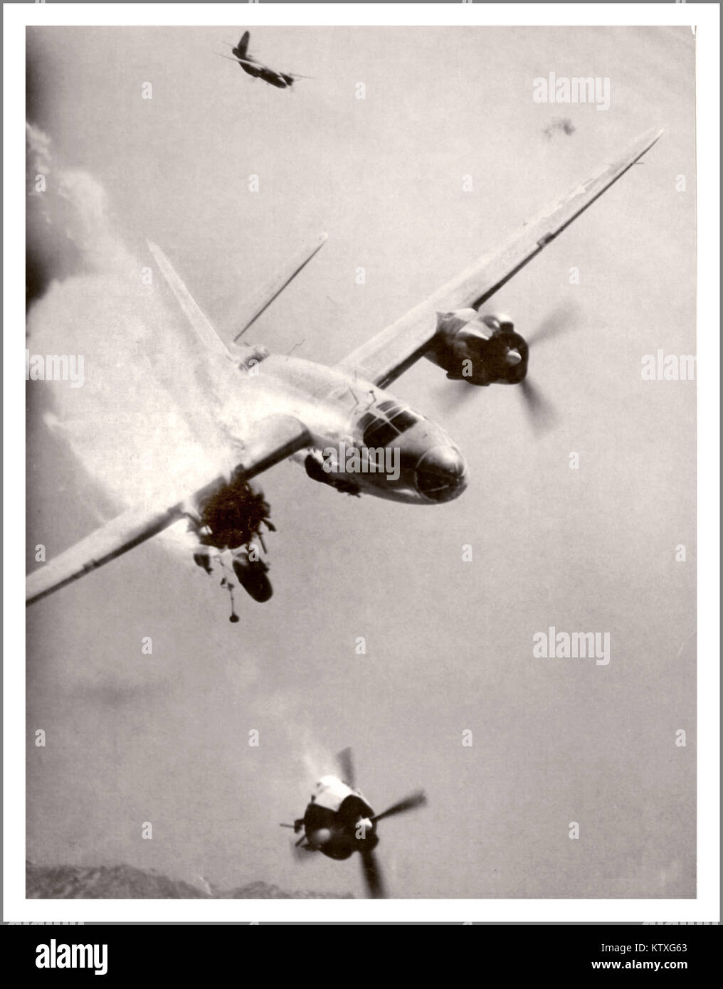 WW2 American Airforce USAAF B26 Bomber shot down in flames over France. Grim remarkable aerial war image, of crippled American B-26 Marauder aircraft after a direct hit by a Nazi German 88 mm flak shell over Toulon Harbour, Southern France. Starboard propeller and engine completely separated.. 3 out of the 6 crew survived this aerial combat incident.. Stock Photo