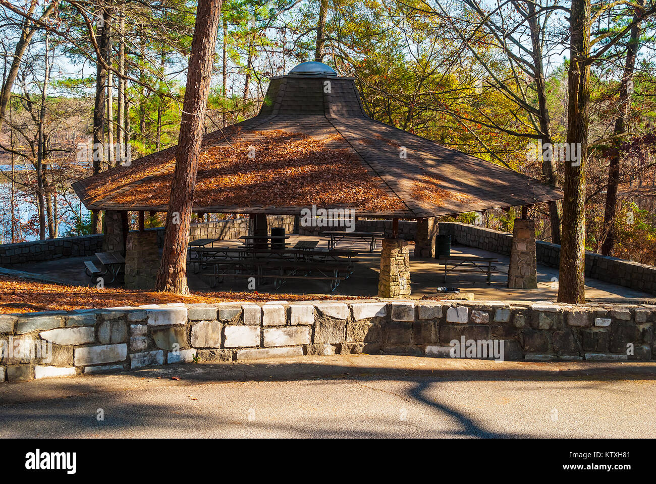Big picnic area with tables and roof in the Stone Mountain Park in sunny autumn day,