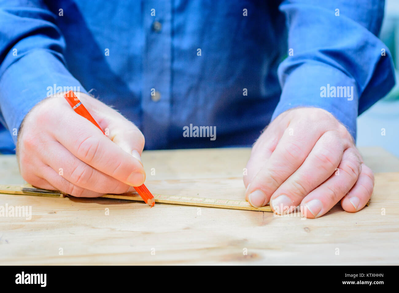 Craftsmen measuring wood with ruler and pen for cutting Stock Photo - Alamy