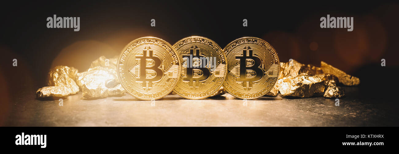 Bitcoin cryptocurrency and mound of gold nuggets  - Business concept image Stock Photo