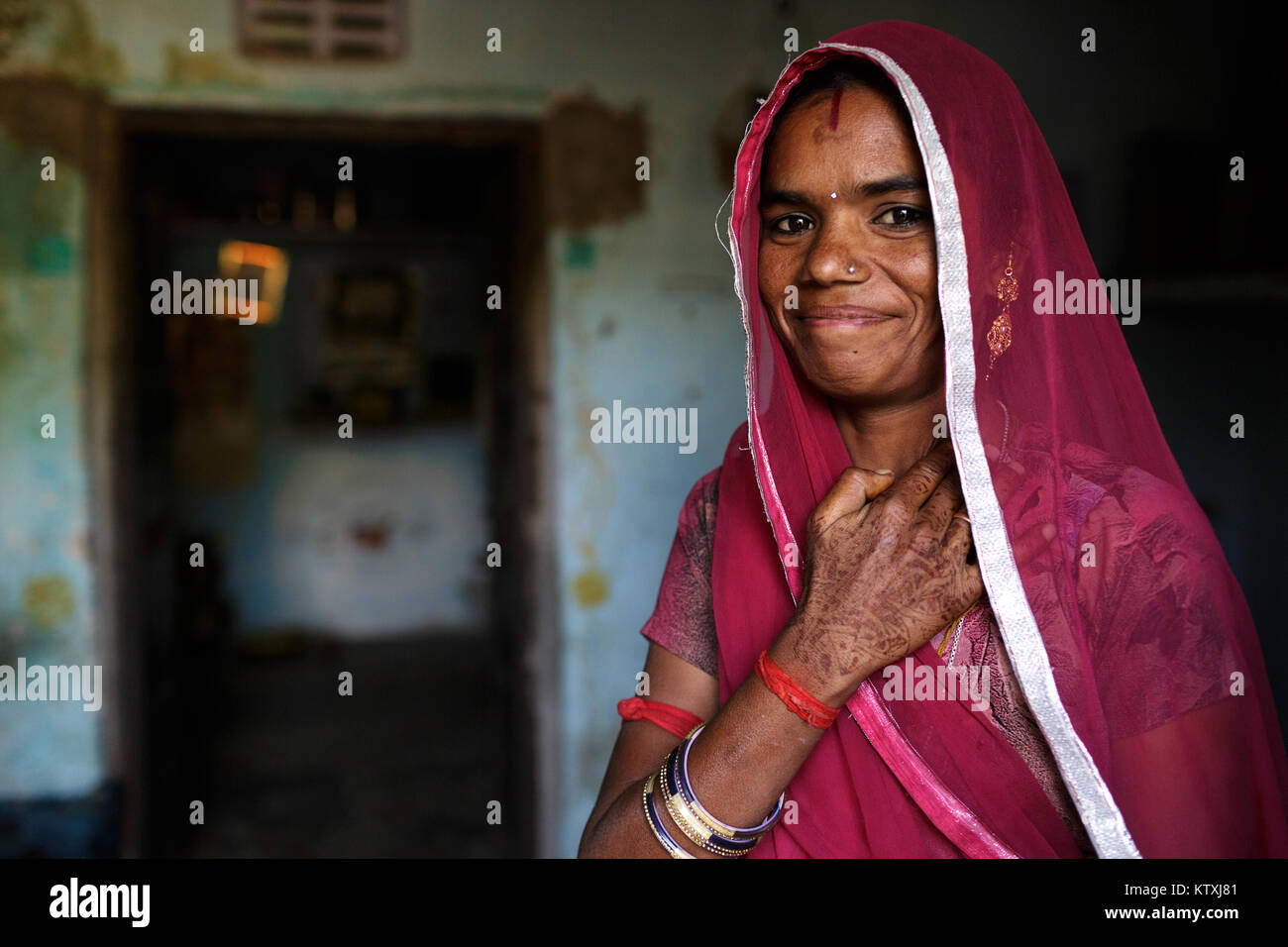 Portrait of smiling young indian woman wearing sari and a veil over her ...