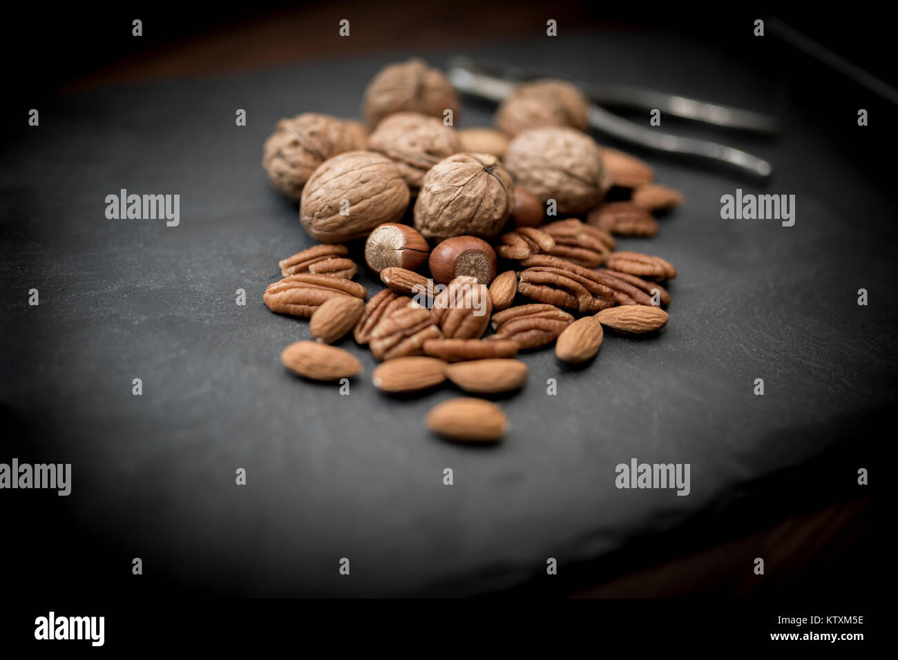 A healthy selection of mixed whole and shelled nuts including walnuts