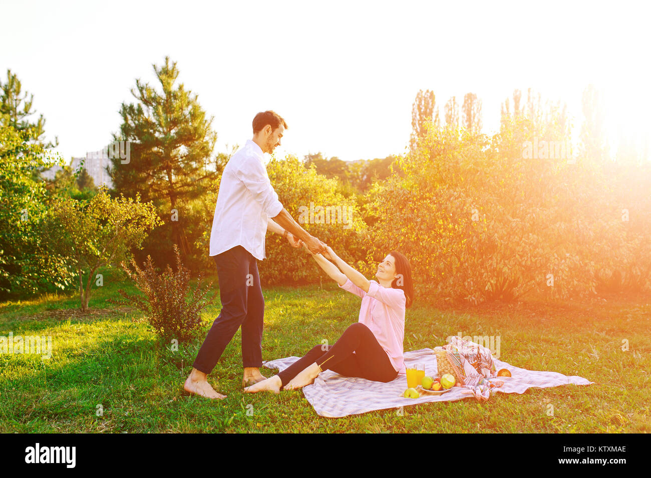 Happy pregnant couple in park on picnik Stock Photo