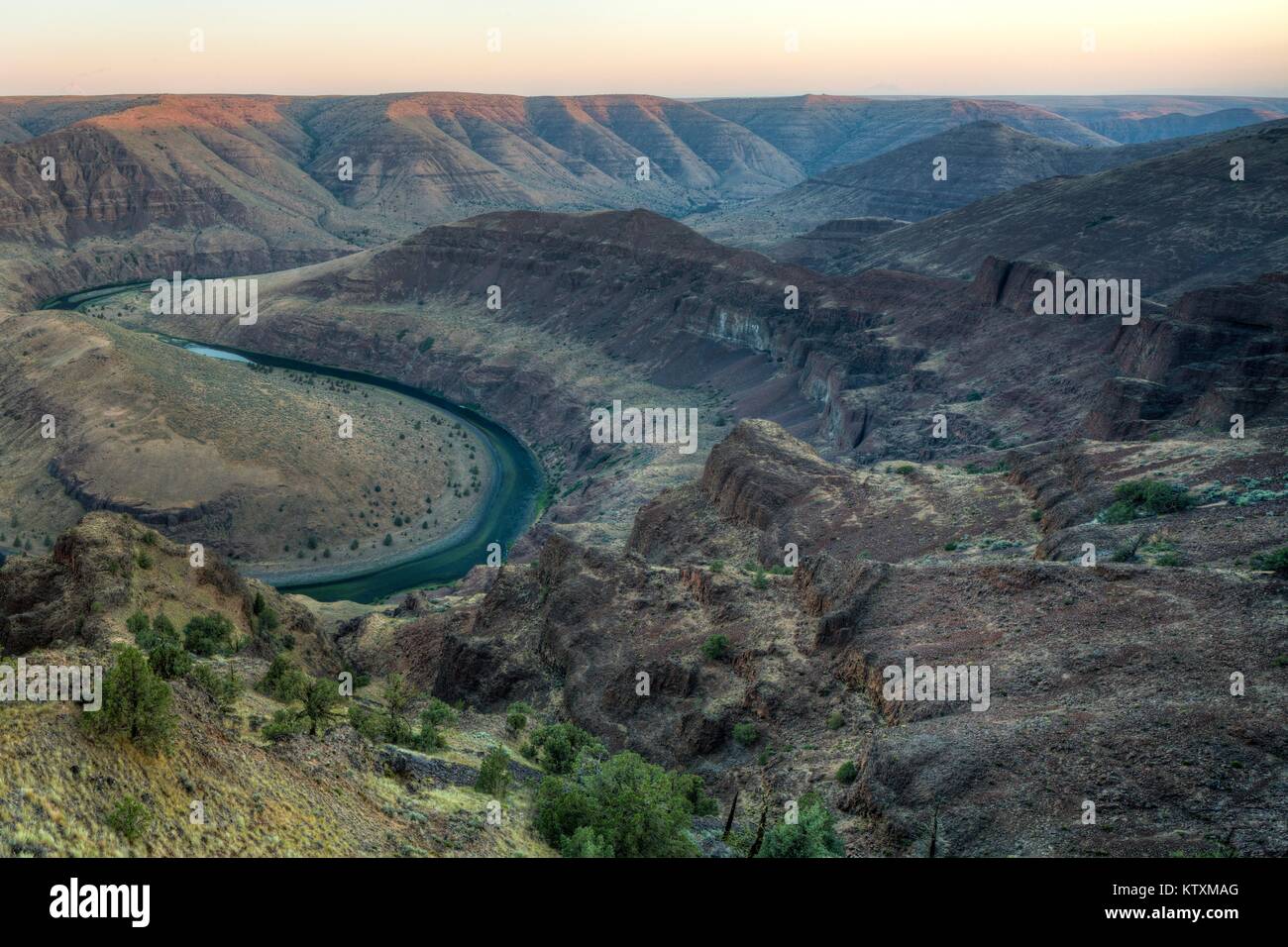 The John Day Wild and Scenic River winds through rock canyons June 9, 2016 in Oregon. Stock Photo