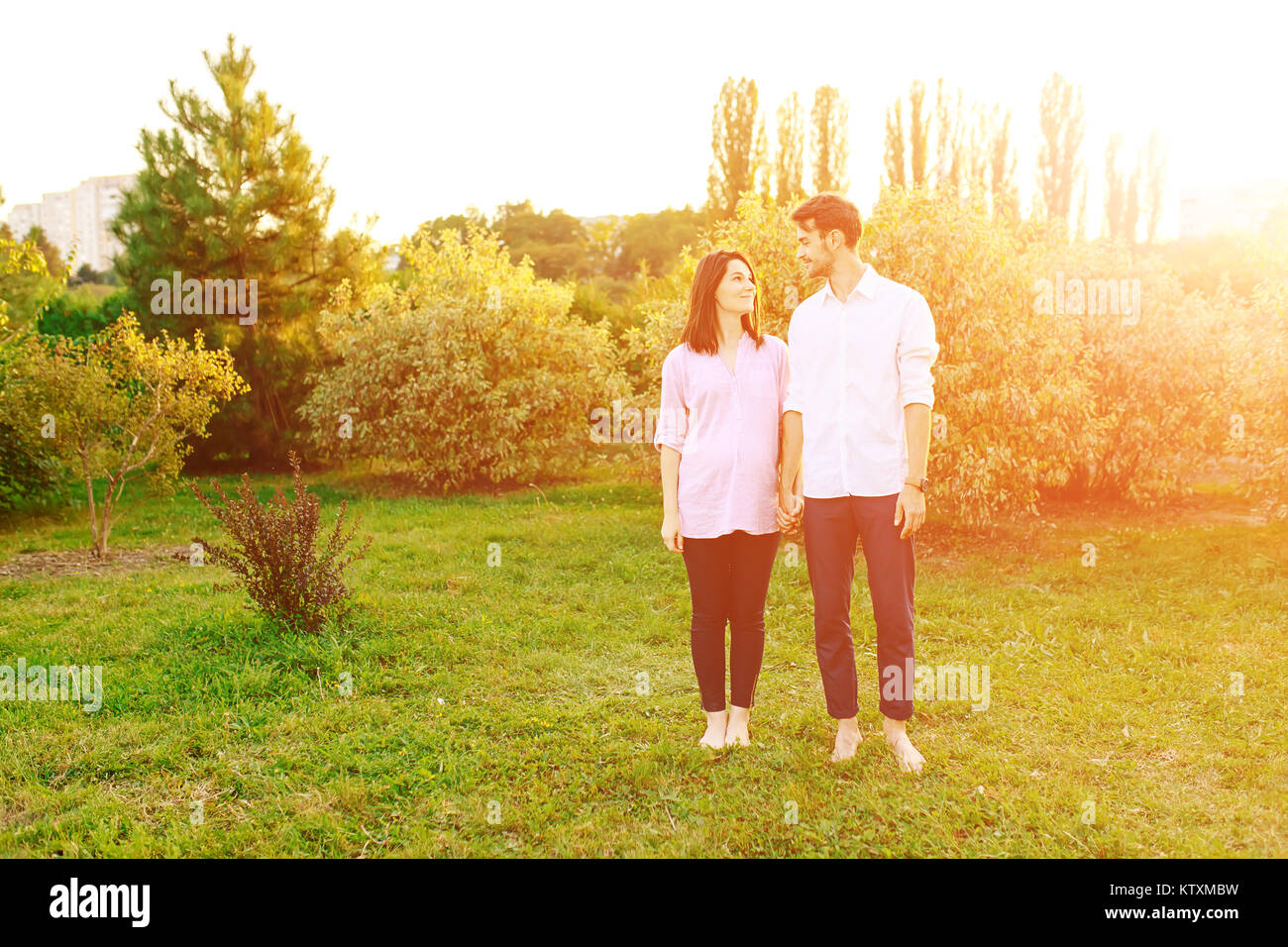 Portrait cheerful pregnant couple in the park Stock Photo - Alamy