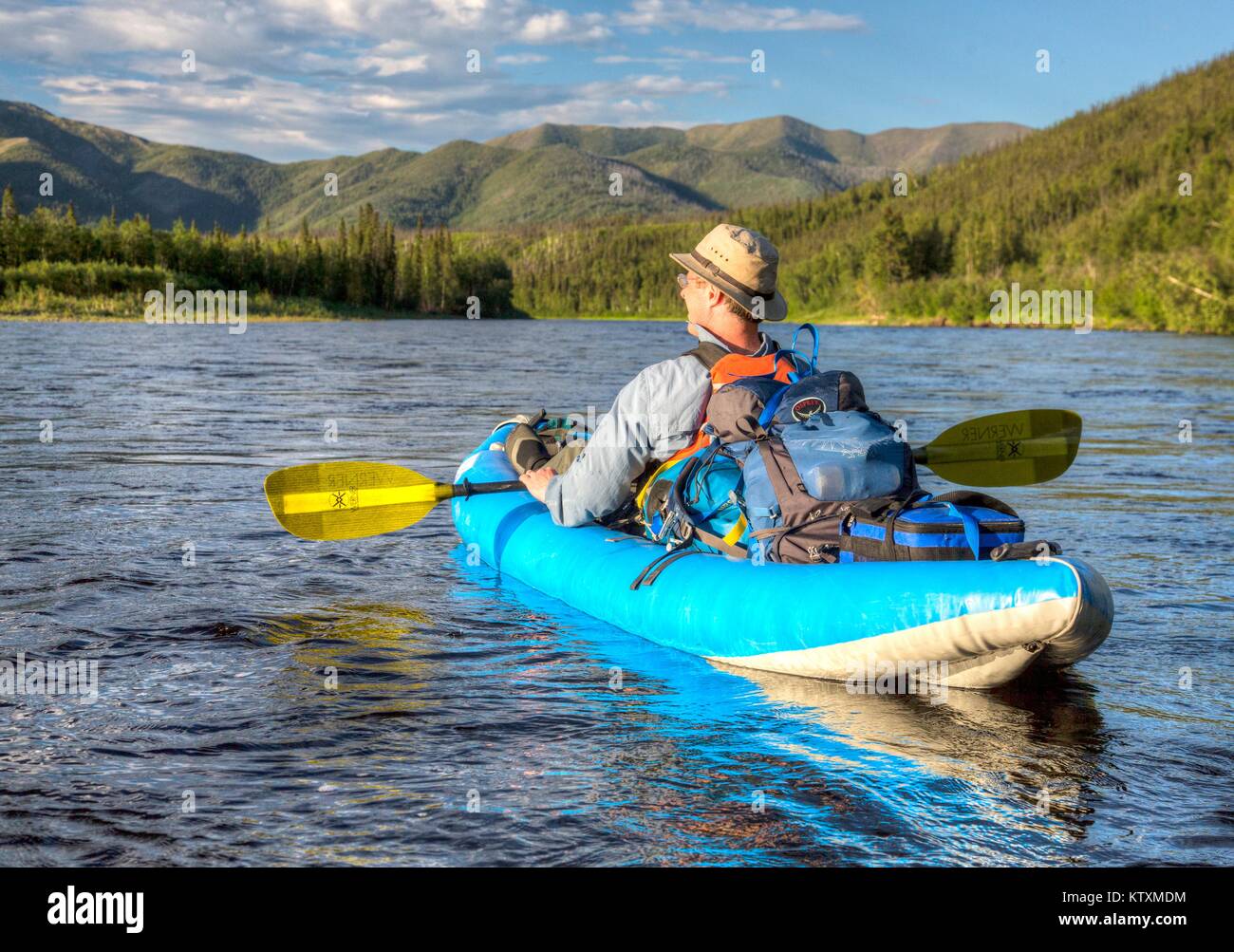 A tourist kayaks down the Beaver Creek Wild and Scenic River June 29, 2014 in Alaska. Stock Photo