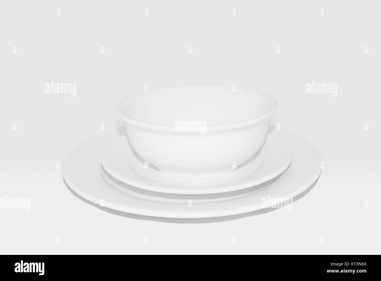 Crockery set including dinner plate, side plate and bowl: White crockery against a white background,100% grayscale. Stock Photo