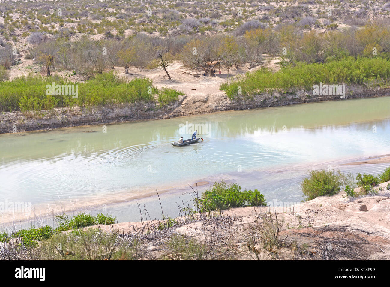 Two People Paddling from the US to Mexico across the Rio Grande in Texas Stock Photo