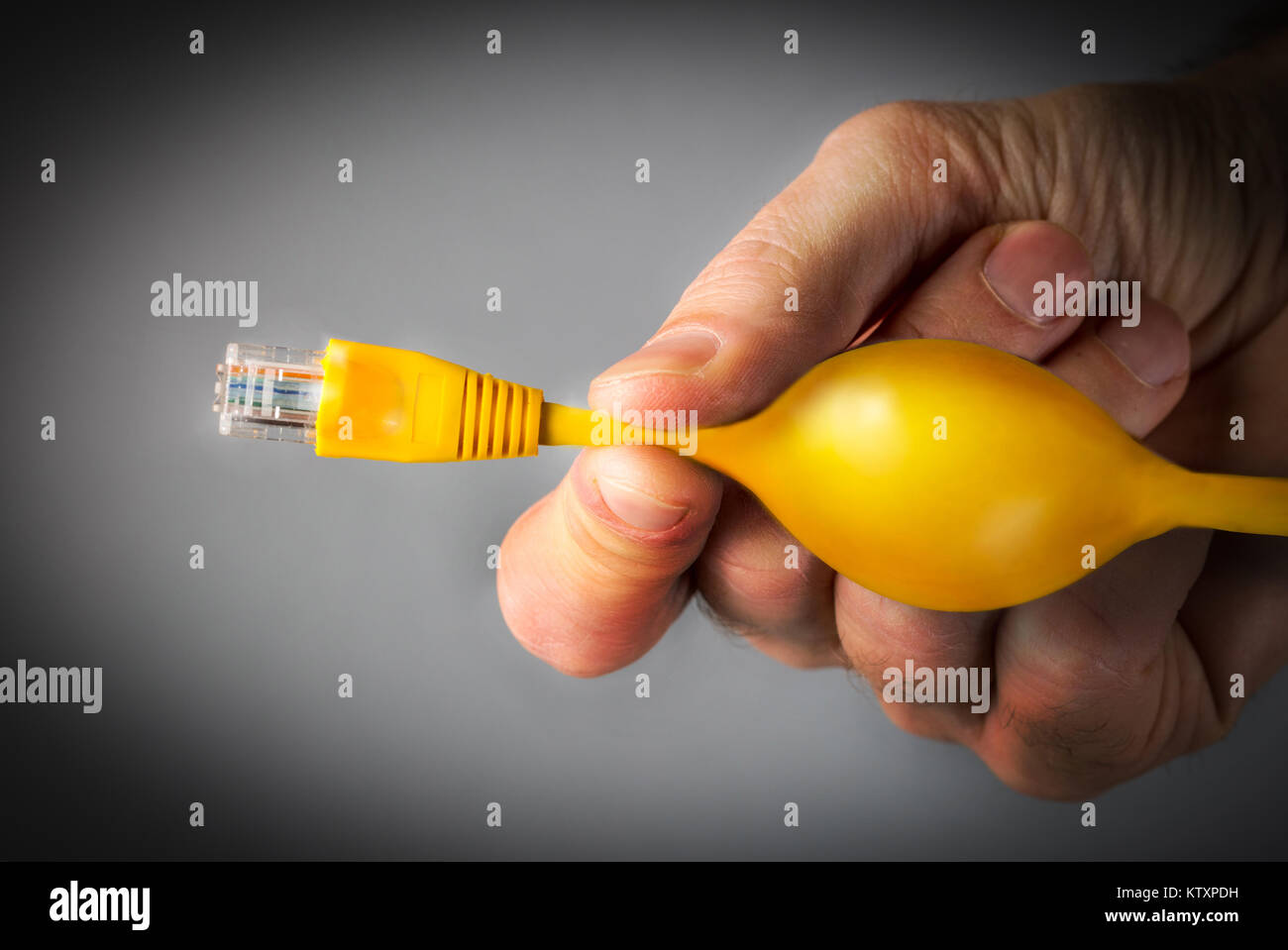 Net Neutrality concept image of a man pinching an ethernet cable to restrict internet access Stock Photo