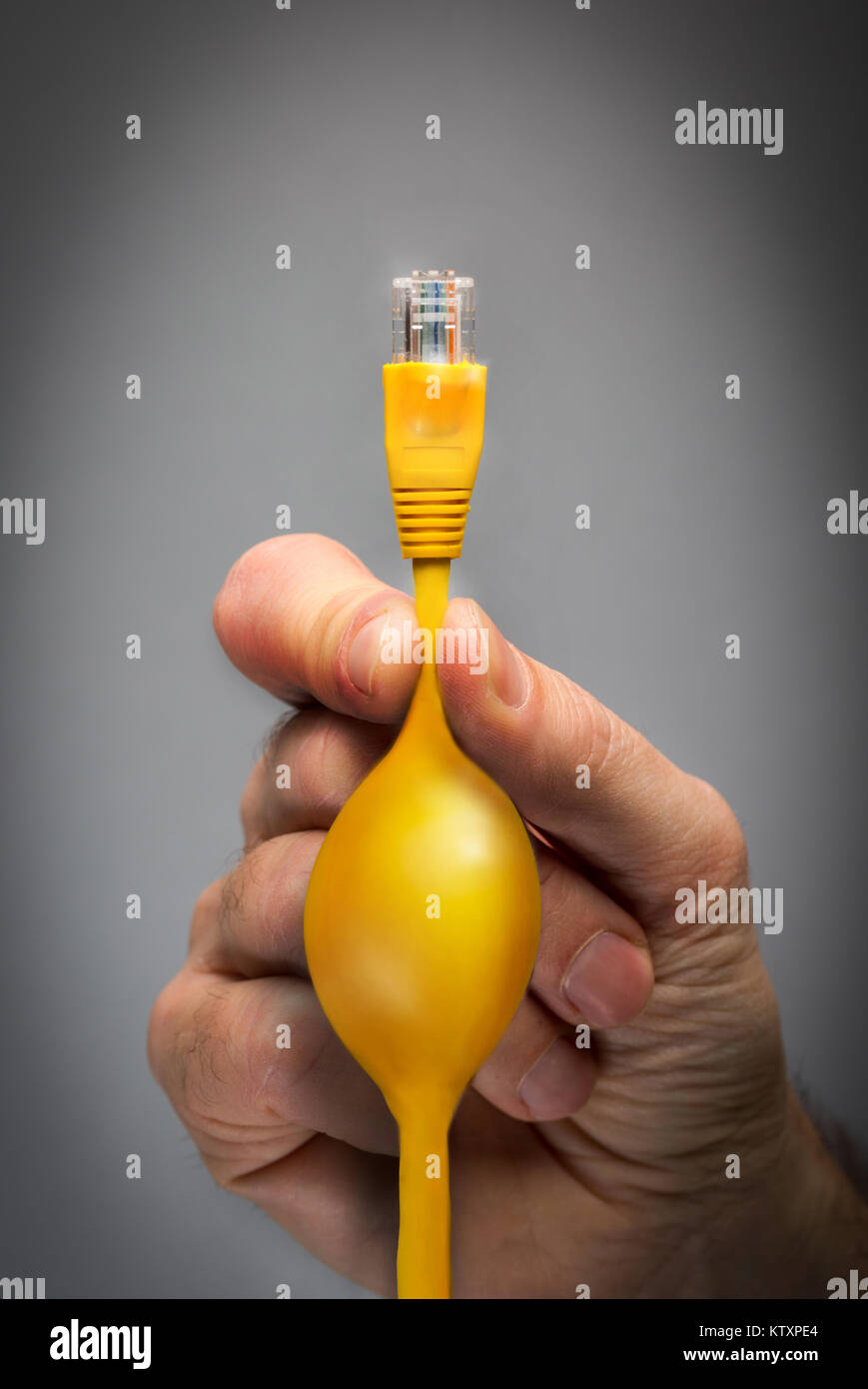 Net Neutrality concept image of a man pinching an ethernet cable to restrict internet access Stock Photo