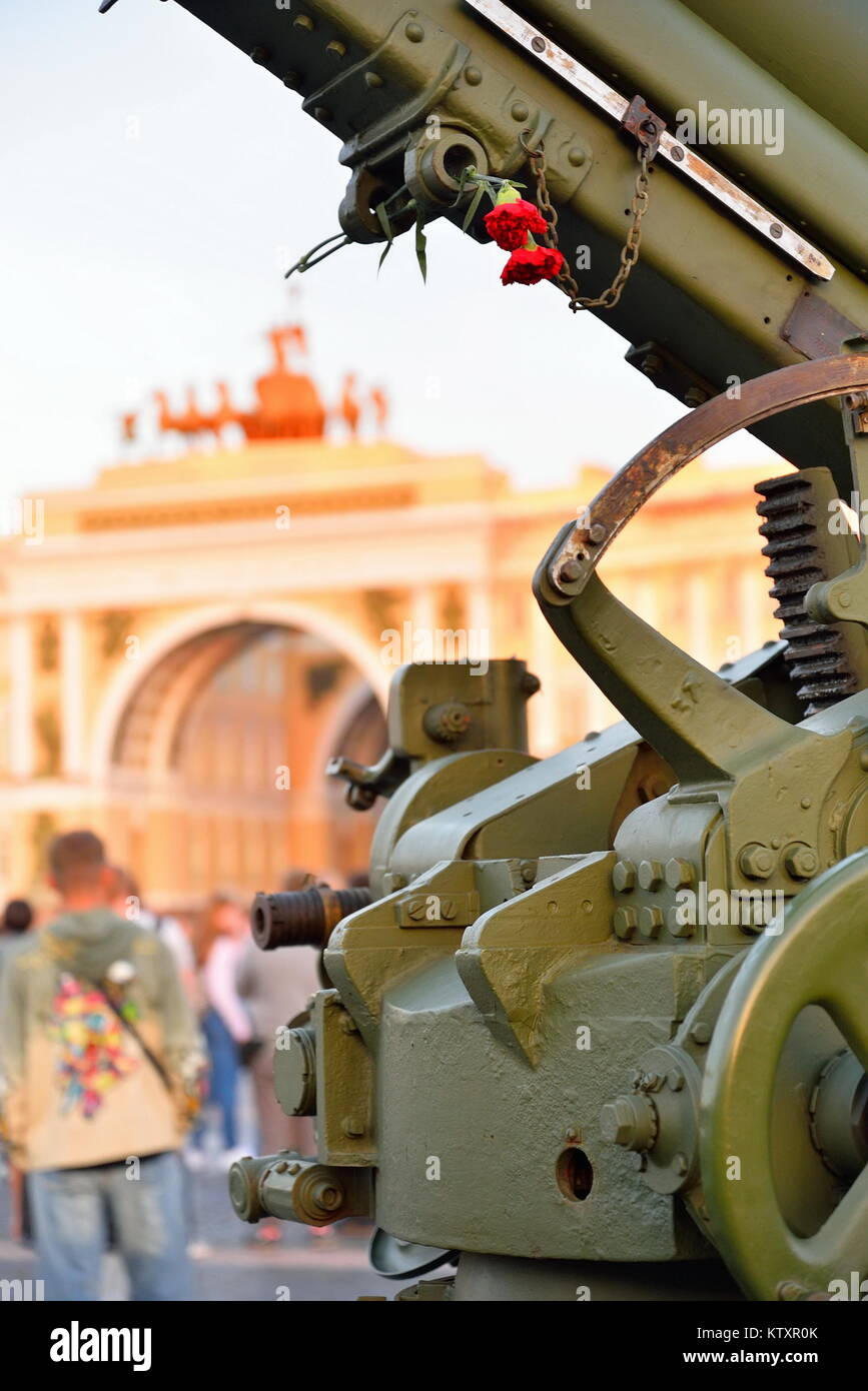 Red carnations on anti-aircraft artillery weapon on Palace squar Stock Photo