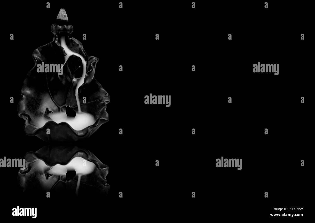 Incense tower burner in black and white background. Dark color and