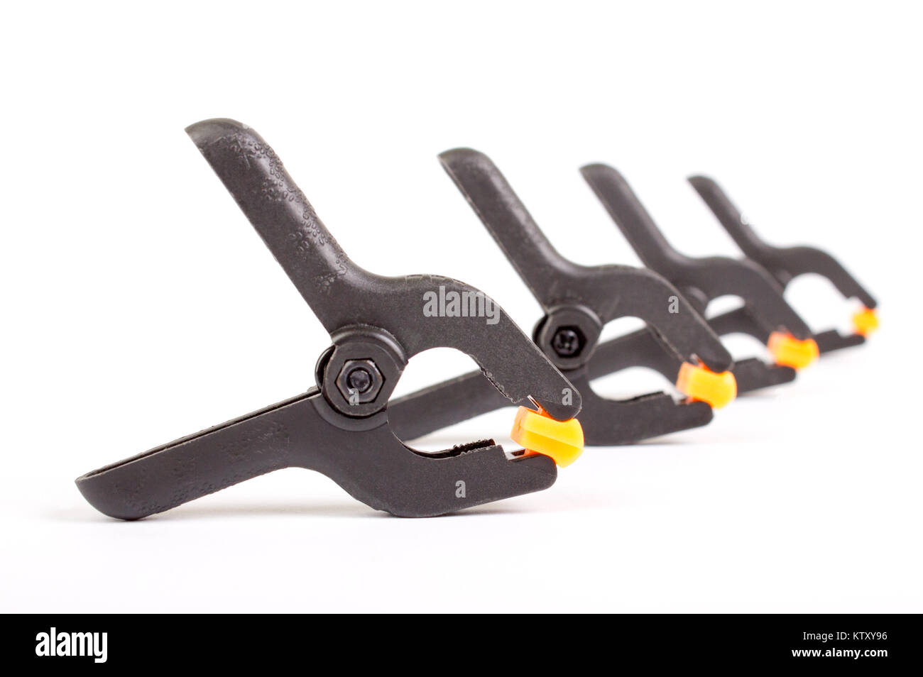 Universal plastic blackorange clamp on white background Stock Photo