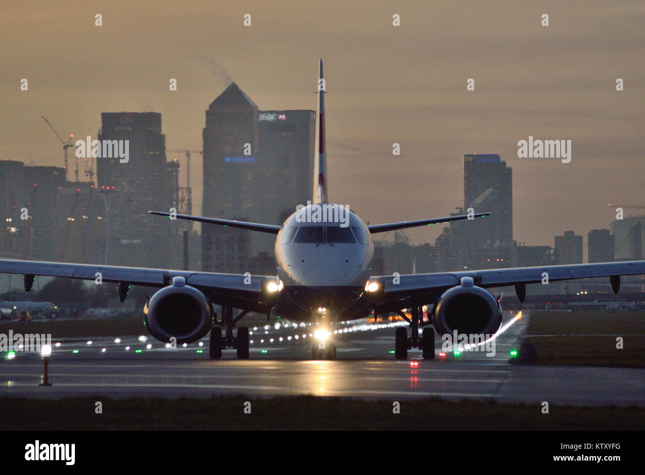 British Airways BA CityFlyer Embraer taxing at London City Airport at dusk Stock Photo