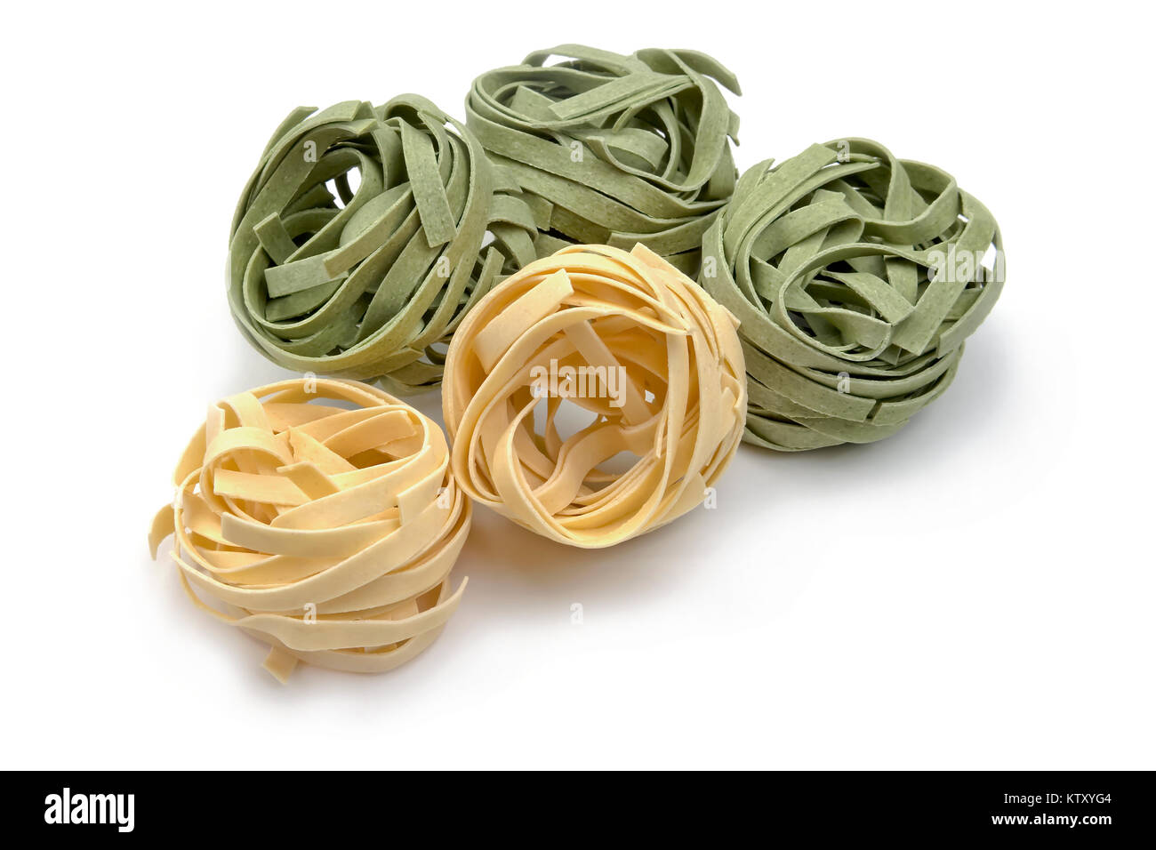 Dried Tagliatelle pasta nests on white background Stock Photo