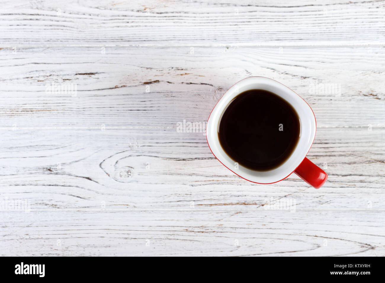 red coffee cup on wood table top view Stock Photo - Alamy