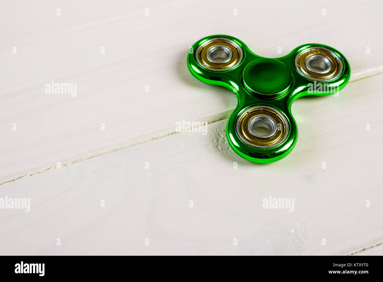 Spinner fidget toy for stress relieving on wood table background with copy  space for your creative design project Stock Photo - Alamy