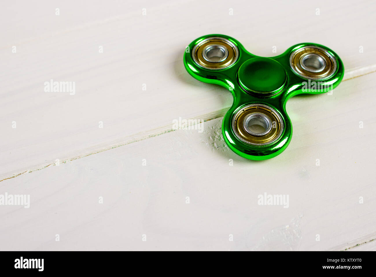 Spinner fidget toy for stress relieving on wood table background with ...