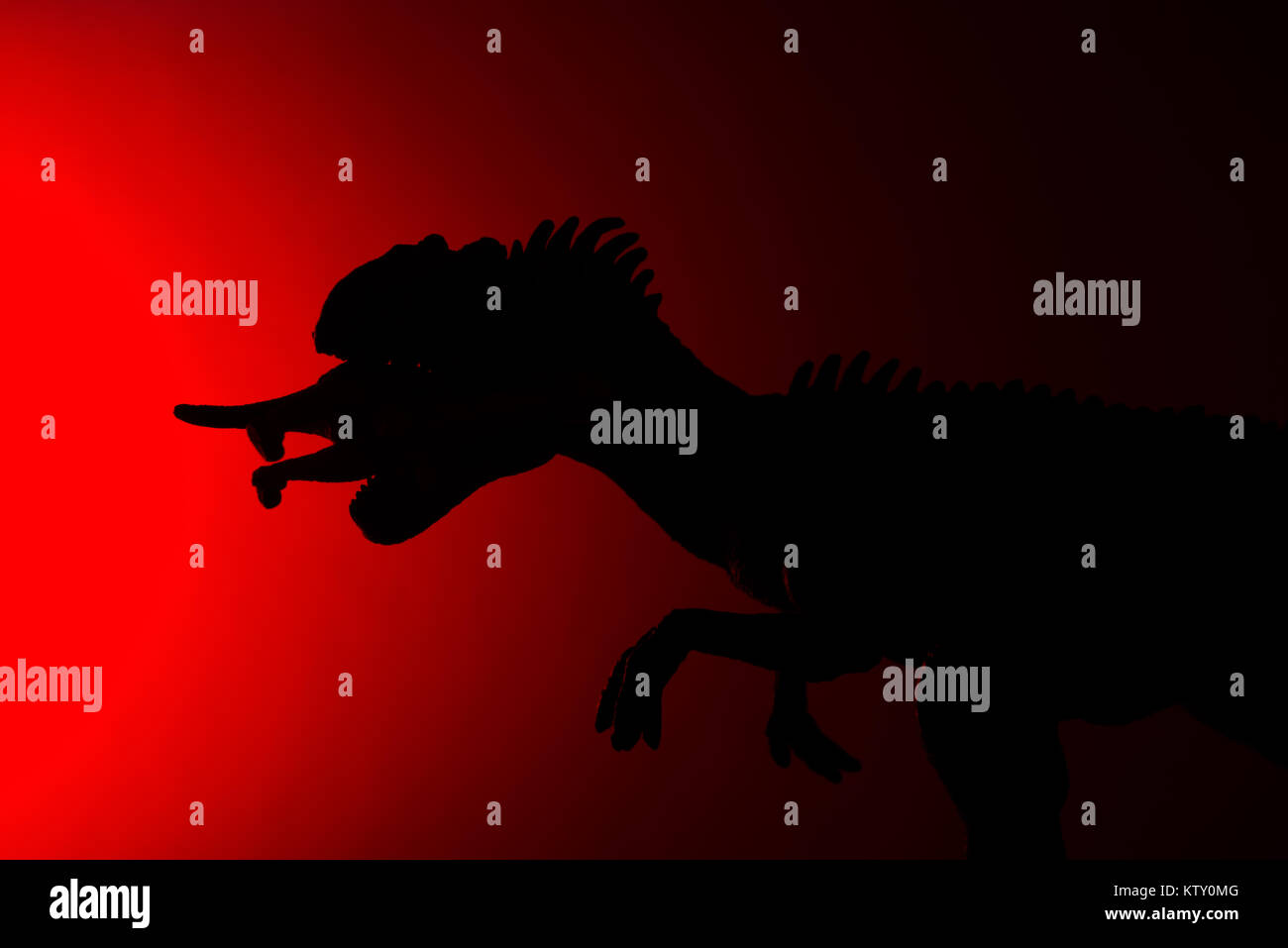 shadow of allosaurus biting a smaller dinosaur with red light in dark ...