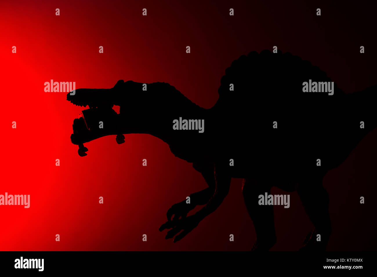 shadow of spinosaurus biting a human body with red light in dark Stock ...