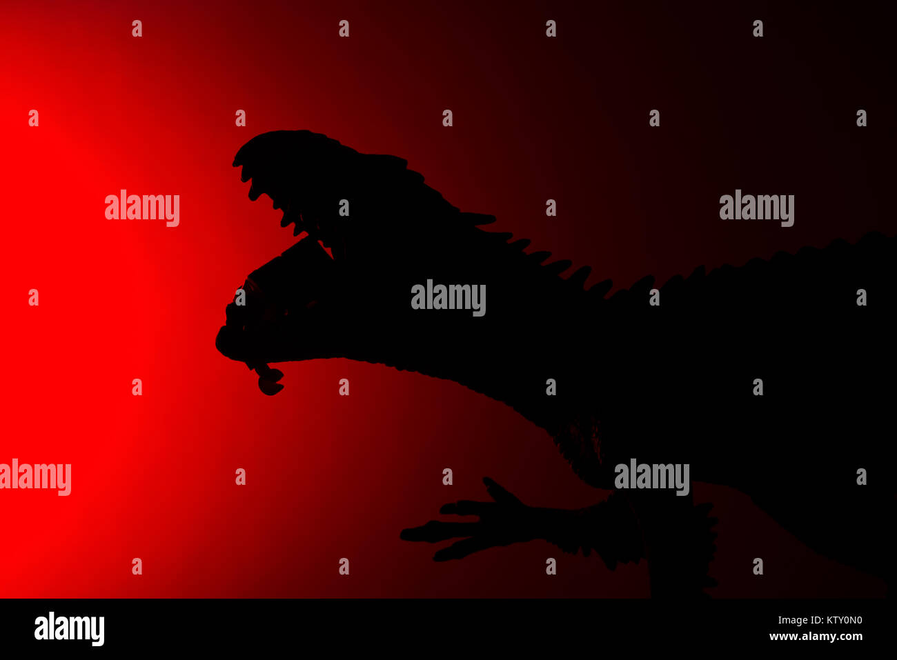 shadow of Carcharodontosaurus biting a human body with red light in ...