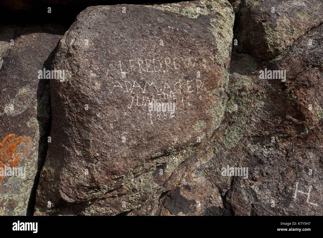 An emigrant pioneer signature is carved into a rock along the Oregon National Historic Trail September 14, 2010 in Oregon. Stock Photo