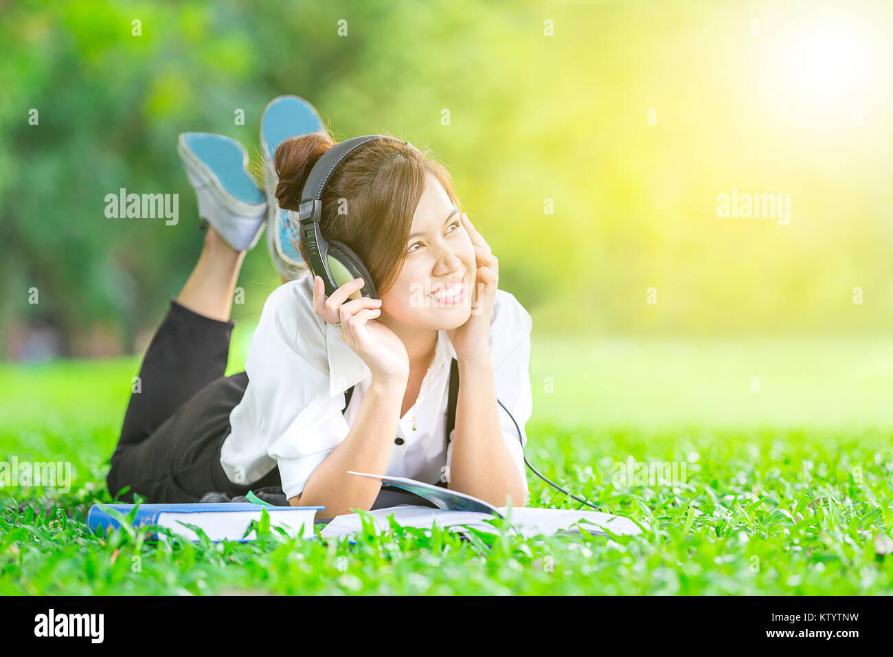 Female Student Read Textbook And Listen Music With Relax And Smile Stock Photo Alamy