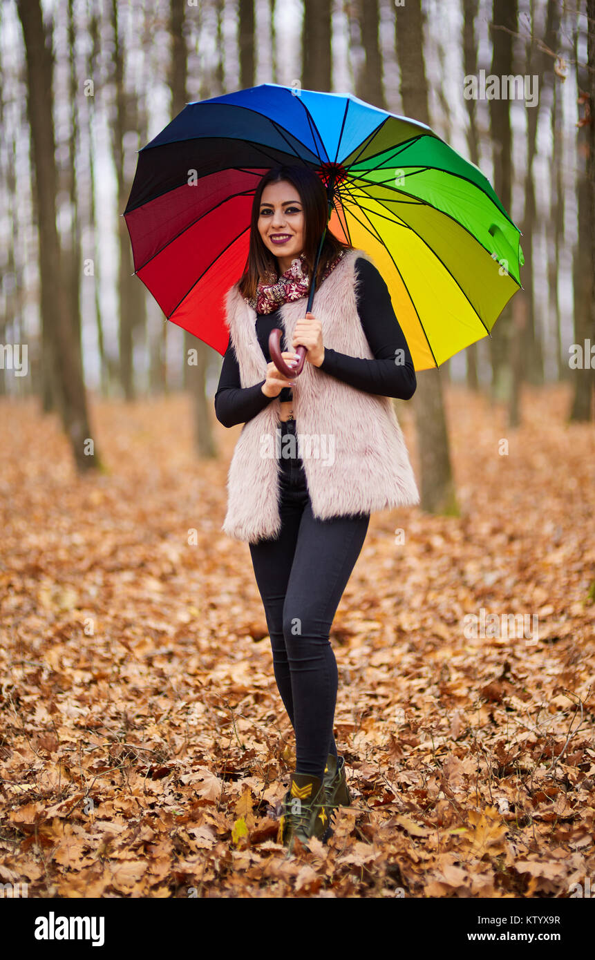 Woman with colorful umbrella walking through the forest Stock Photo - Alamy