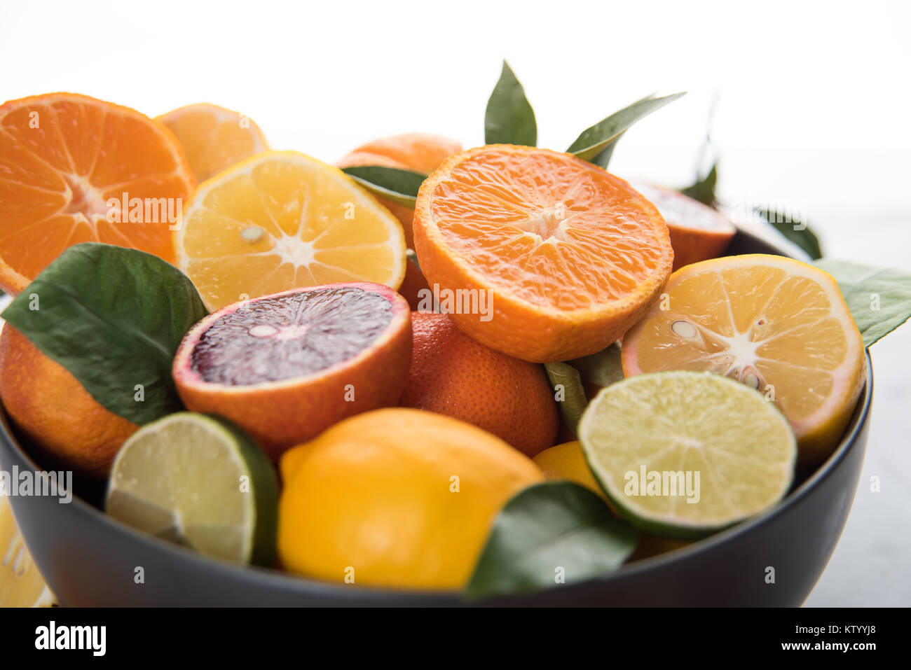Fresh Blood Oranges, limes, and Lemons in Bowl on Marble Table Stock ...