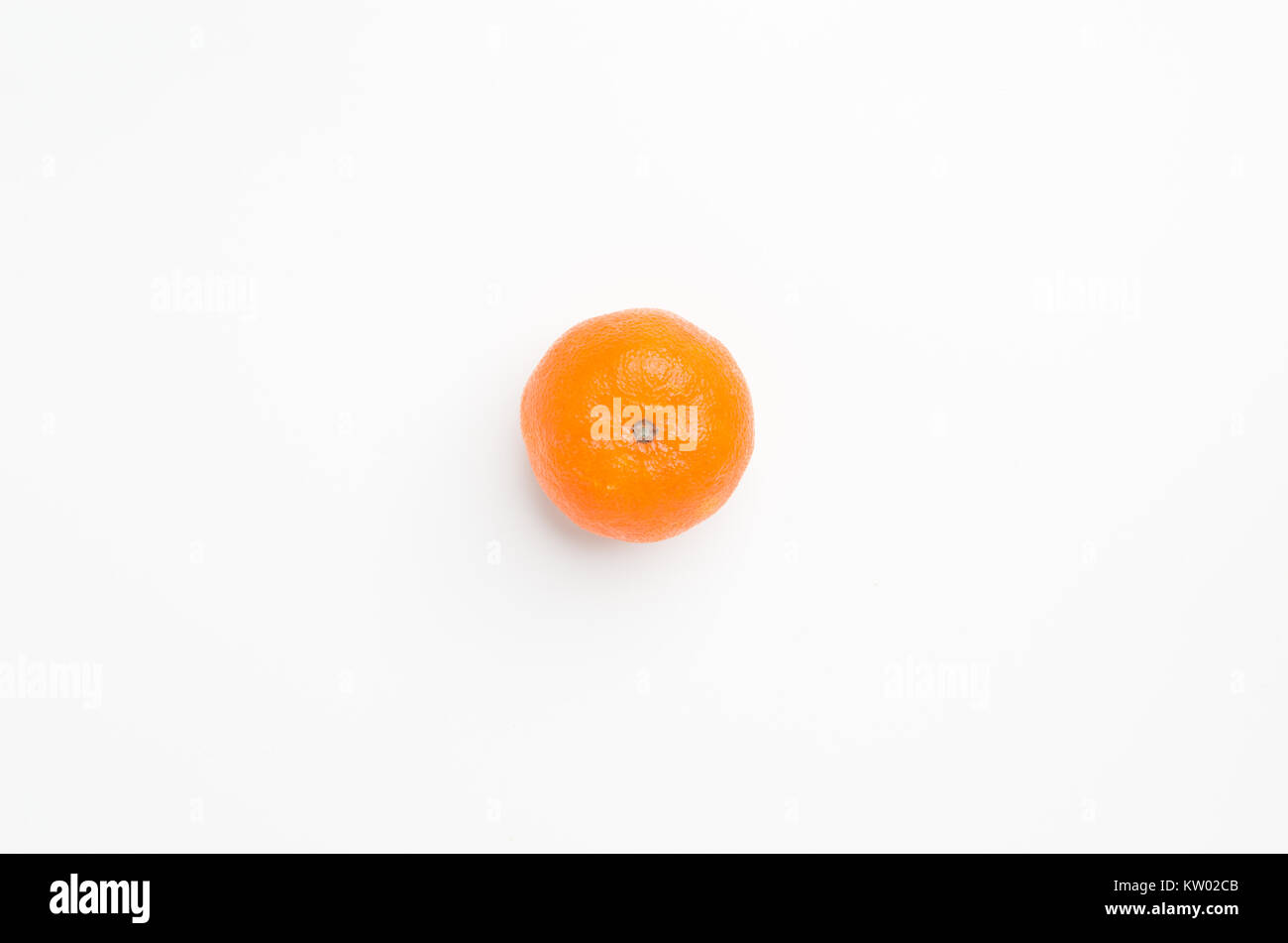 Top view flat lay of fresh mandarine/clementine isolated on white background, with lots of empty space to add some copy and messaging. Stock Photo