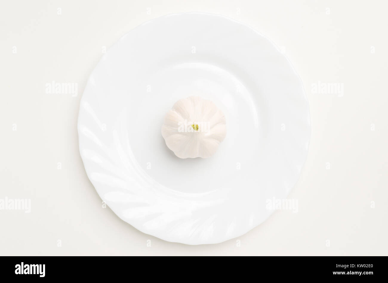 Top view flat lay of garlic isolated on white plate on white background. Stock Photo