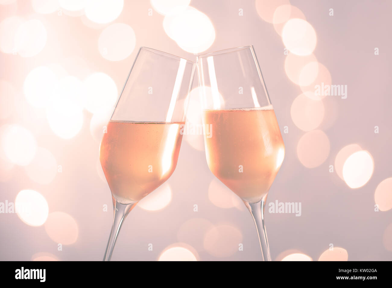 toasting with champagne glasses in front of a blurred background Stock